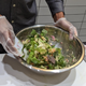 Chopt salad being mixed in bowl by employee